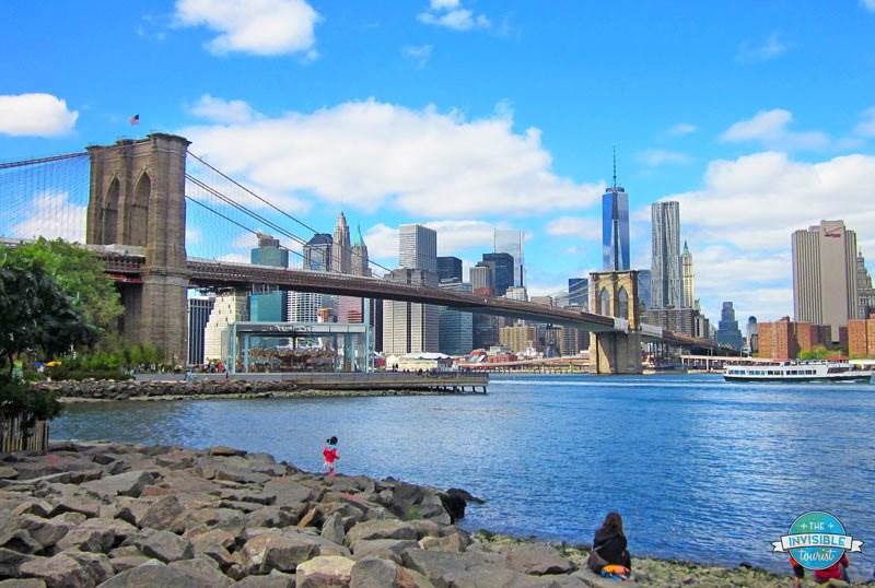 Brooklyn Bridge over East River with One World Trade Center over on Manhattan